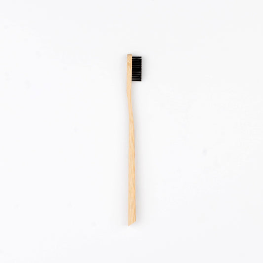 Biodegradable bamboo toothbrush with charcoal bristles