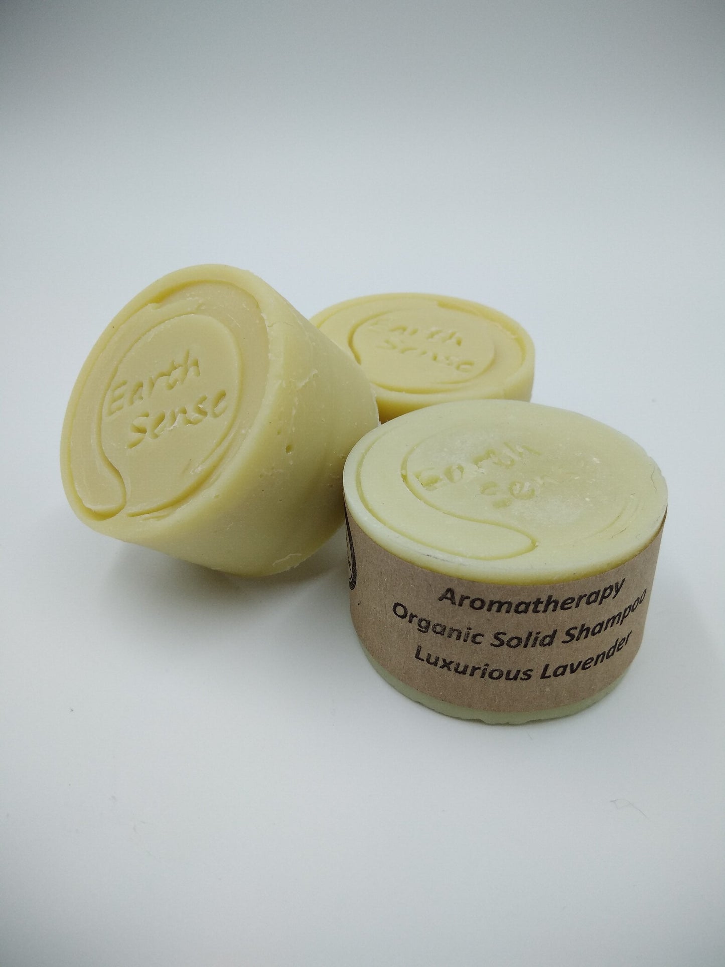 Two organic solid shampoo bars with 'Earth Sense' branding on a white background