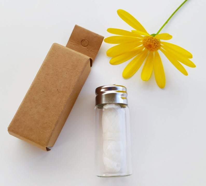 Charcoal dental floss in reusable glass bottle eco friendly