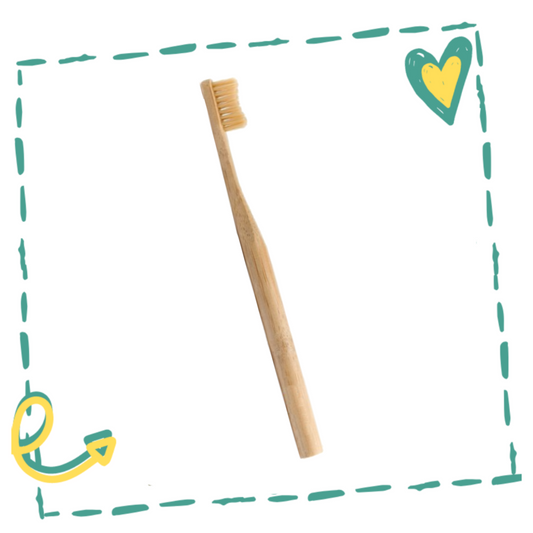 Bamboo toothbrush on a white background with decorative elements.