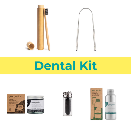 Dental kit with bamboo toothbrush, metal interdental brush, and georganics products on a white background.